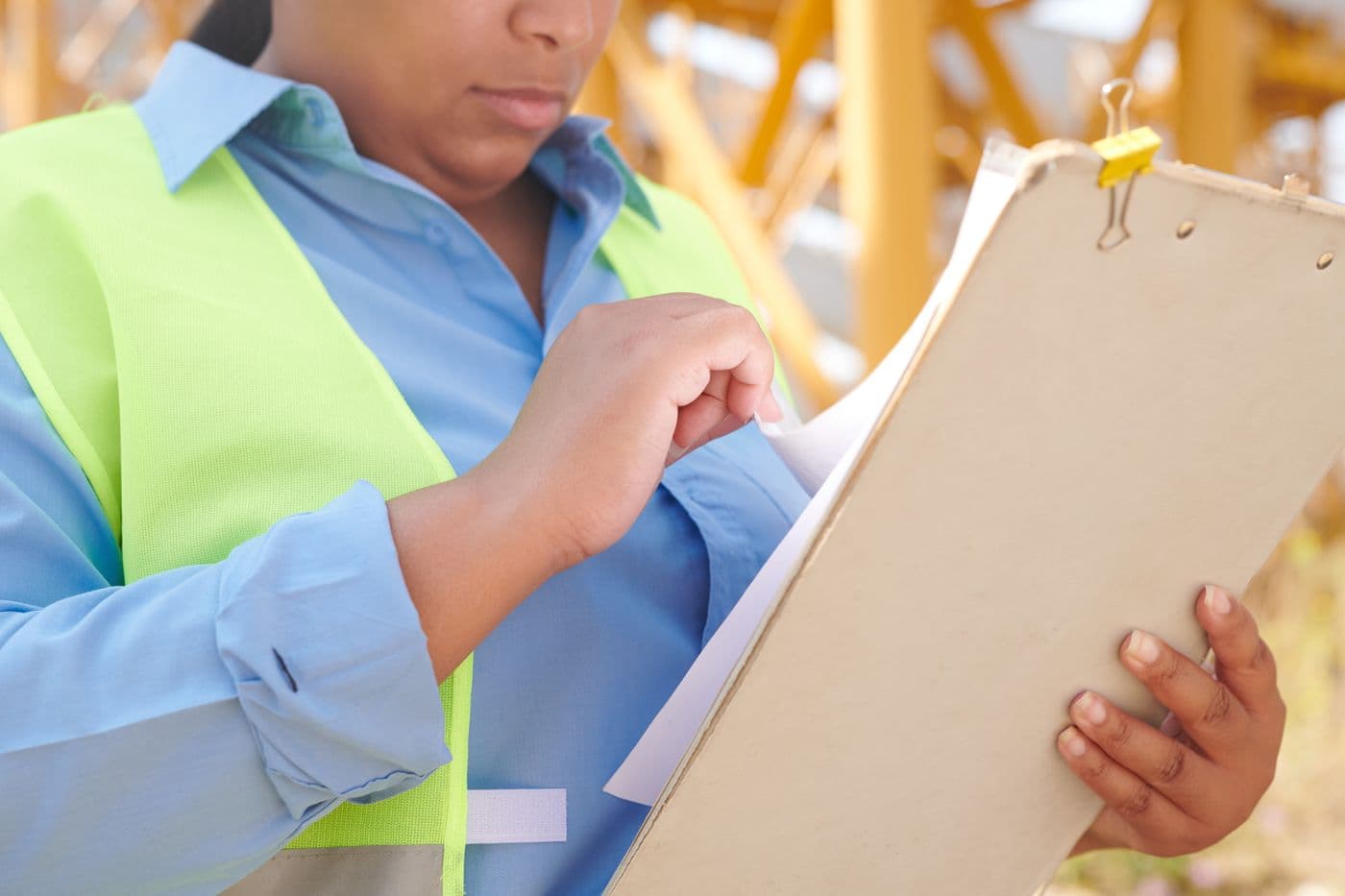 Worker reviewing a clipboard at a construction site
